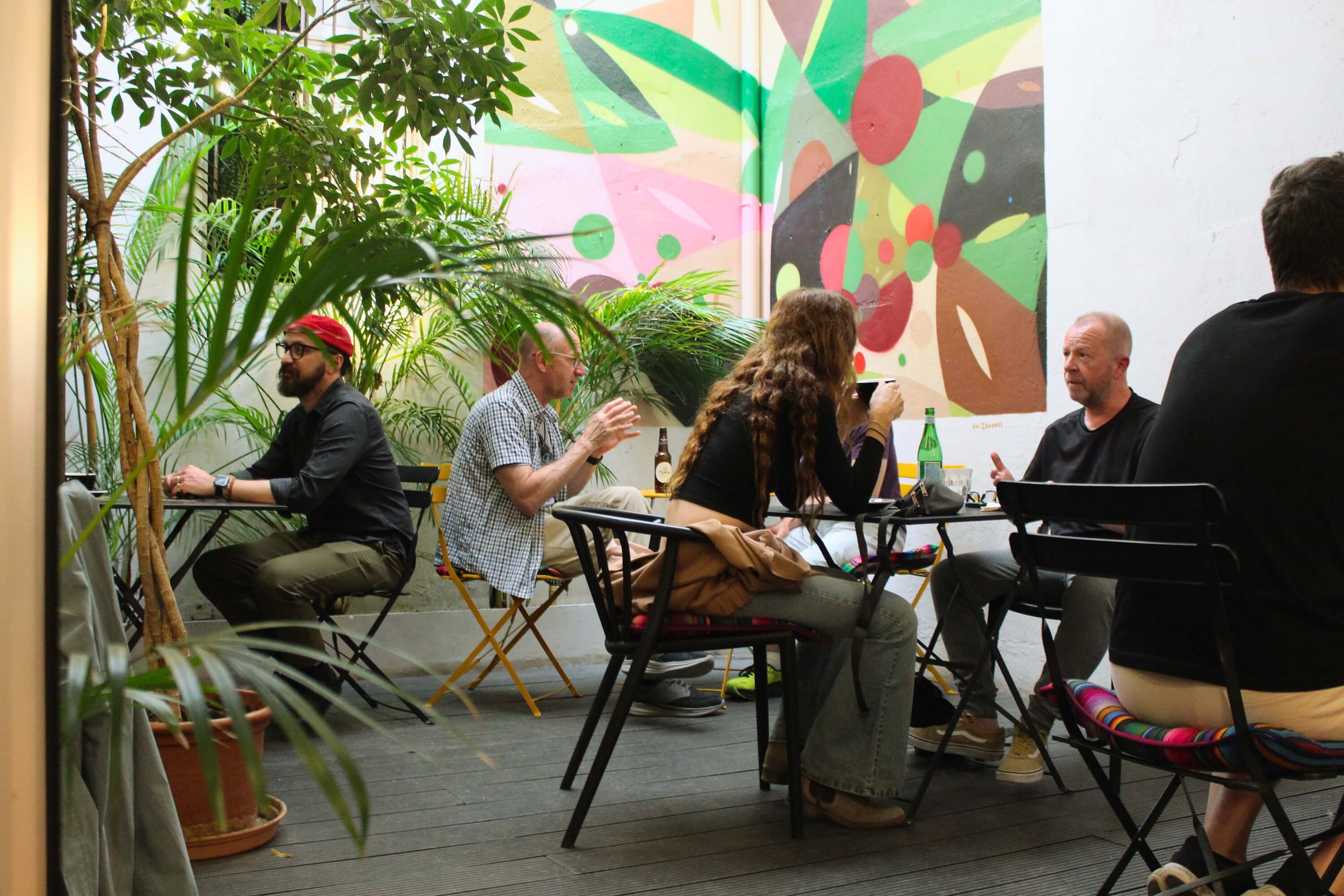 A small group of people having relaxed conversations at an Introverts Social Club event